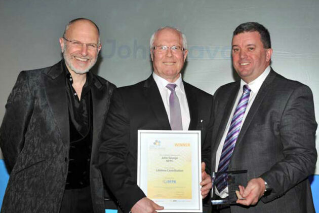 Mr John R Savage, the founder and Director of the National Fluid Power Centre (NFPC) receiving his award