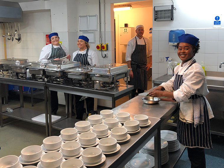 Students working in a commercial kitchen.
