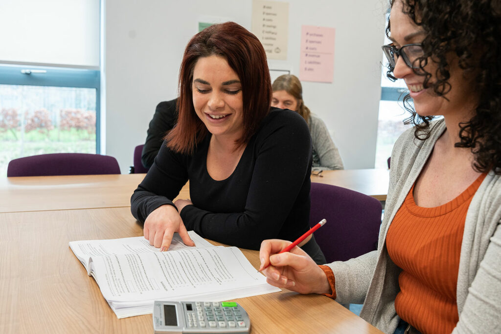 Two adult learners sat at a table