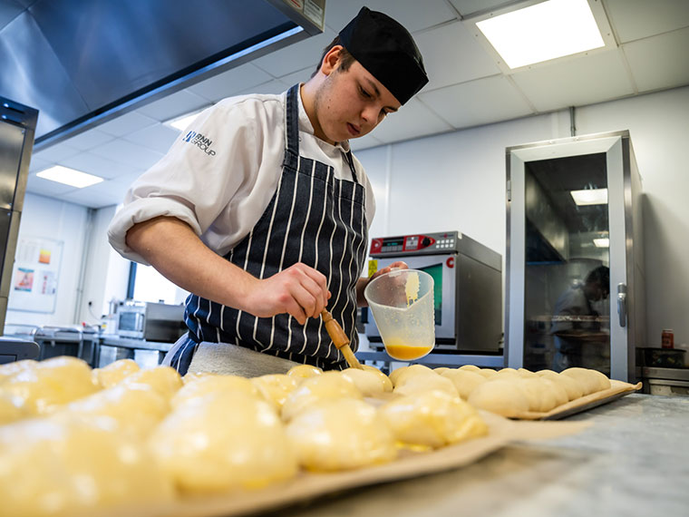 A catering student working in the kitchen