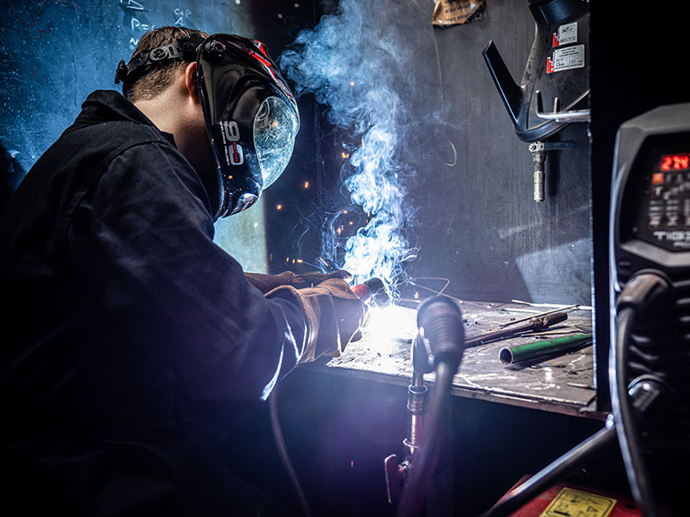A fabrication and welding student welding