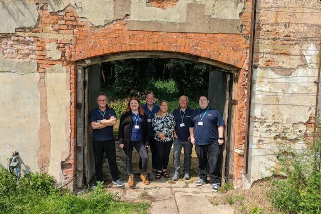 Staff members stood in the Gateway at the walled garden.