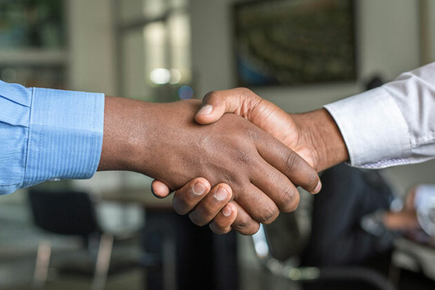 A close up of two people shaking hands