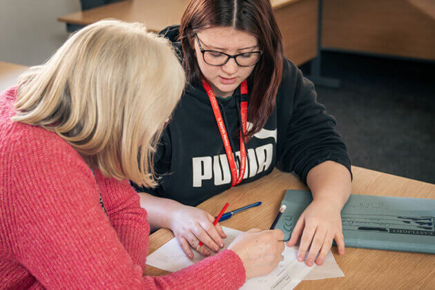 A lecturer supporting a student