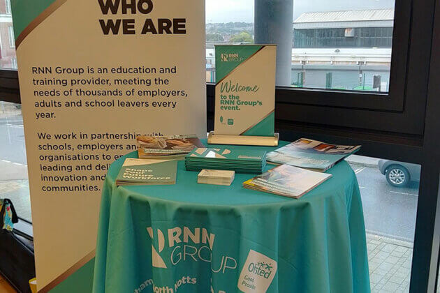 A table and banner display at the RNN Group Business Breakfast