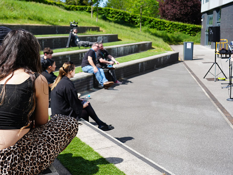 A student band playing in the outdoor amphitheatre in University Centre Rotherham during the HE Fair