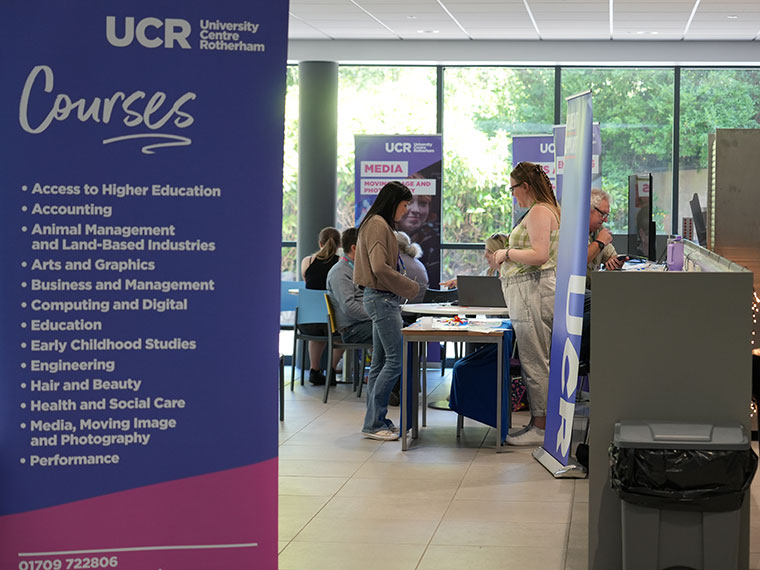 Two people chatting at the HE Fair