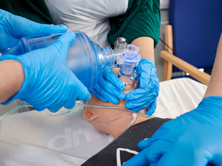 Health students practising resuscitating someone in the health suite