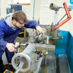 An engineering student using machinery