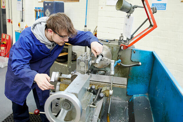 An engineering student using machinery