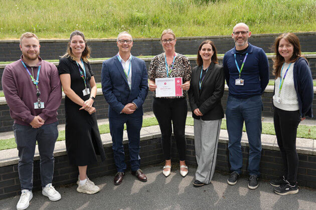 Helena Hague stood with colleagues after receiving a kudo award