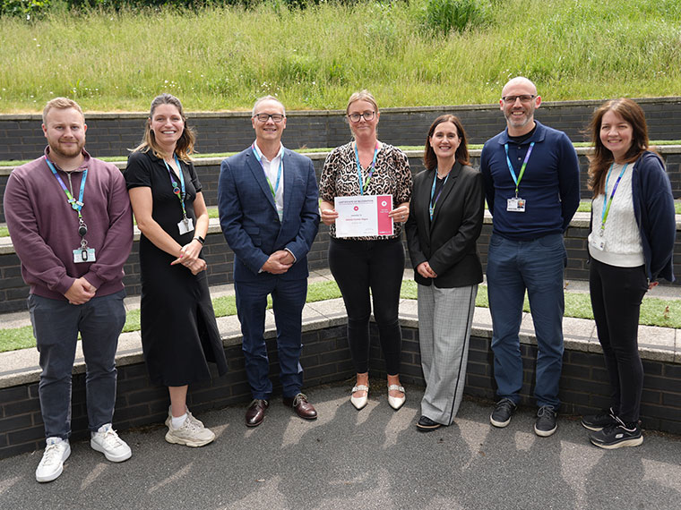 Helena Hague stood with colleagues after receiving a kudo award