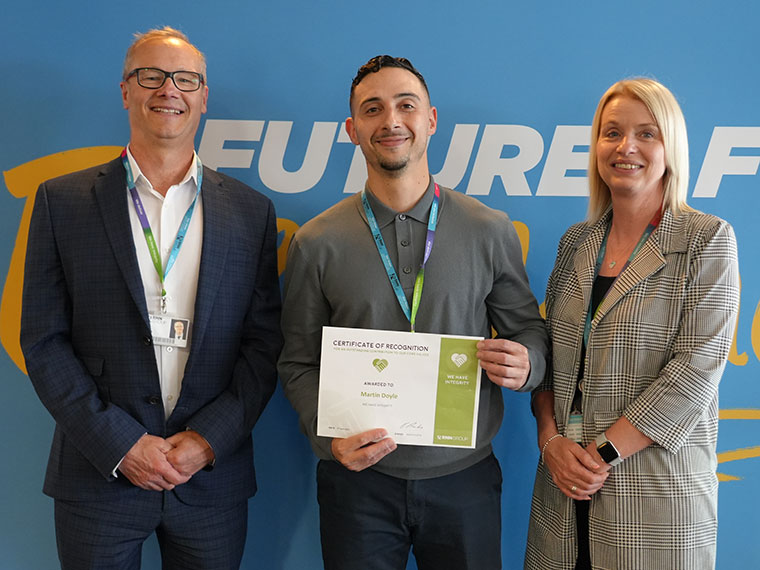 Martin Doyle stood with colleagues after receiving a kudo award
