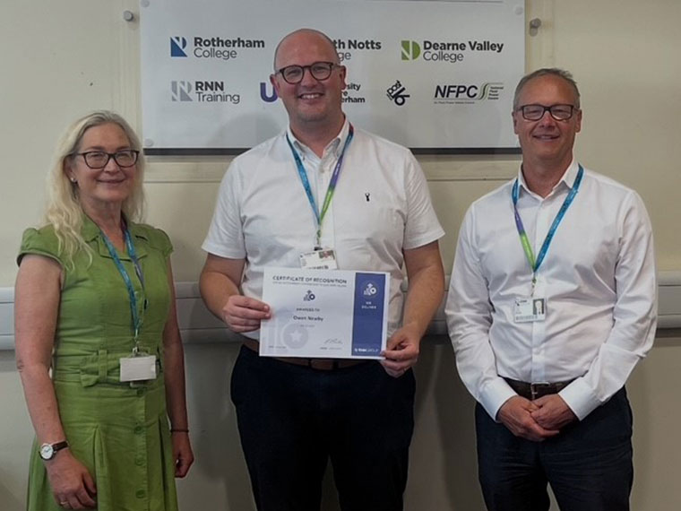 Owen Newby receiving a kudo award from CEO and Principal Jason Austin and Executive Director of HR and Marketing Jane Hartog