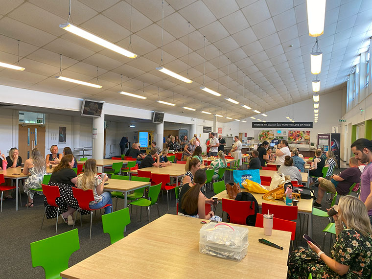 Staff gathering in the canteen for the staff bake off