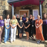 A group of people celebrating the partnership between Rotherham College, North Notts College, Dearne Valley College and Weston Park Cancer Charity