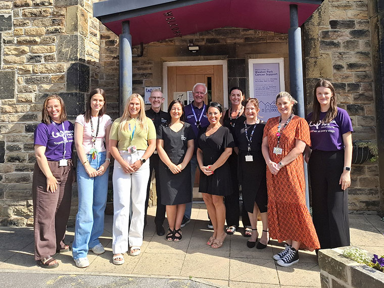 A group of people celebrating the partnership between Rotherham College, North Notts College, Dearne Valley College and Weston Park Cancer Charity