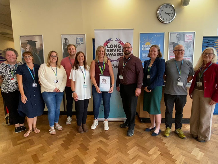 Lucy Kingston celebrating 20 years of  service with colleagues at  RNN Group