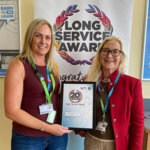 Lucy Kingston being awarded her 20 year service award by Jane Hartog