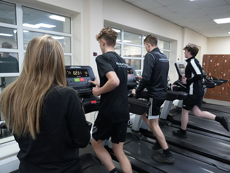 Momentous Football Academy training in the gym on treadmills