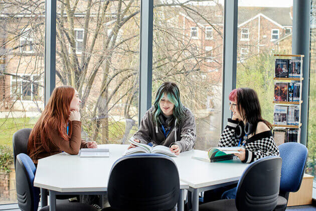 Three UCR students sat at a table