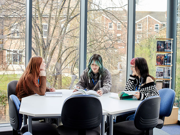 Three UCR students sat at a table