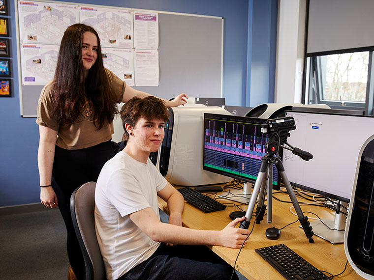 Two students using media equipment