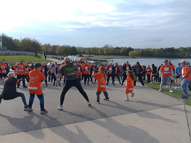 Sarah from Mission Nutrition delivering a warm up to the walkers