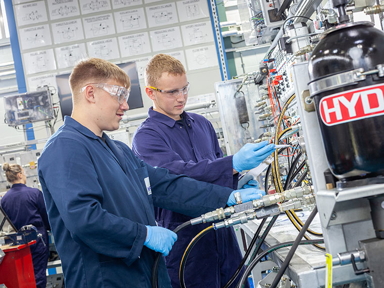 Two NFPC students looking at lots of cables