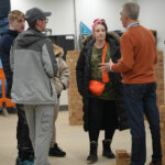 People stood in the bricklaying workshop speaking to a tutor