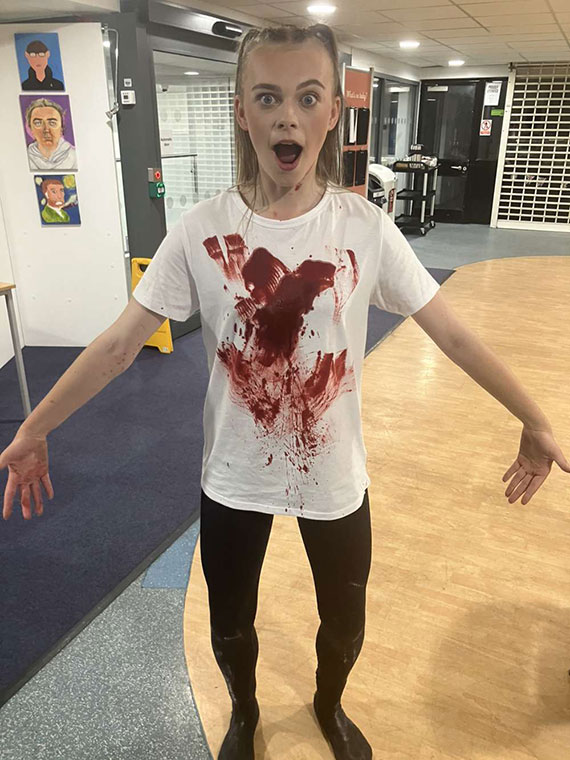 Performing Arts student Alea wearing a white T shirt with fake blood on for a performance