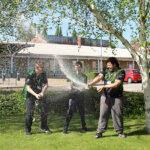 Three esports students celebrating winning a competition