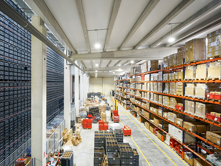 A large warehouse with lots of boxes on large shelves