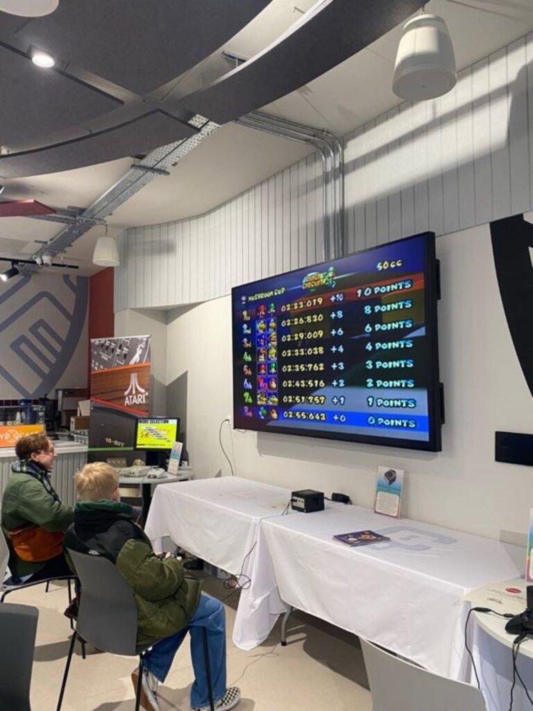 People sitting in front of a computer screen inside The Bridge Skills Hub in Worksop