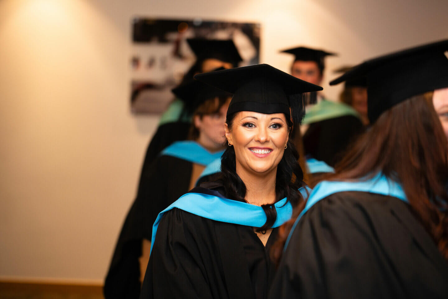 A smiling student about to graduate