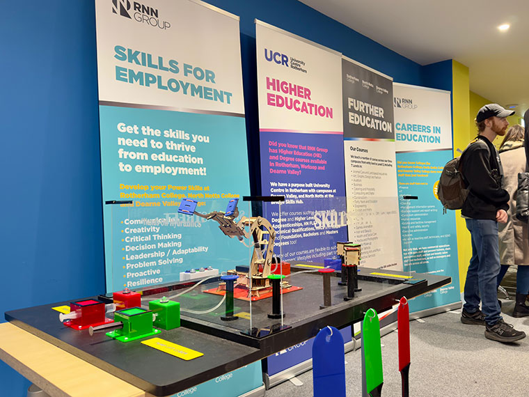 A line of different pull up banners against a wall in a room