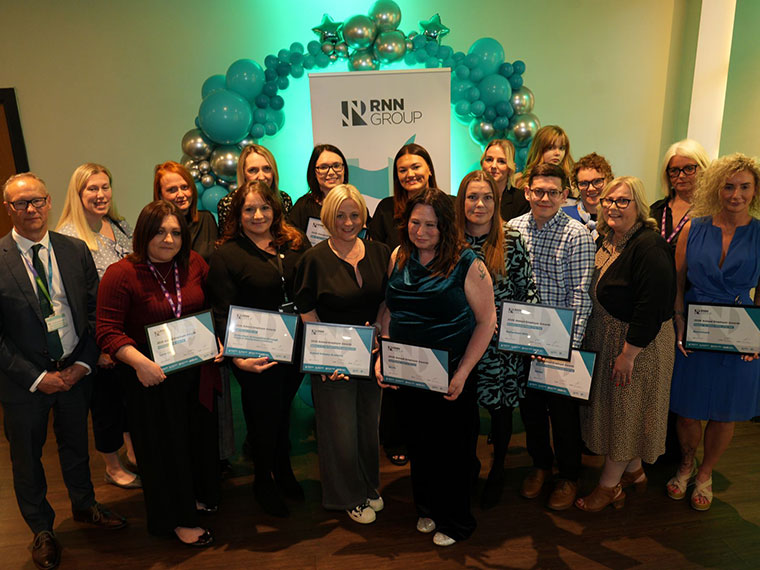A group of people holding their certificates at the RNN Group's Employer Awards