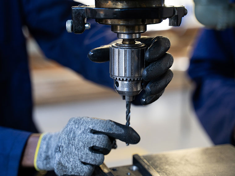 A close up of someone's hands holding some engineering equipment