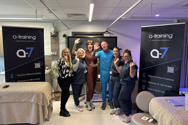 Six people stood together with two beauty therapy beds next to them and three a-training pull up banners