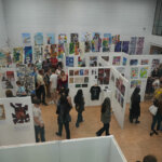 Rotherham College's creative showcase 2025 - People looking at student's artwork hung on the wall