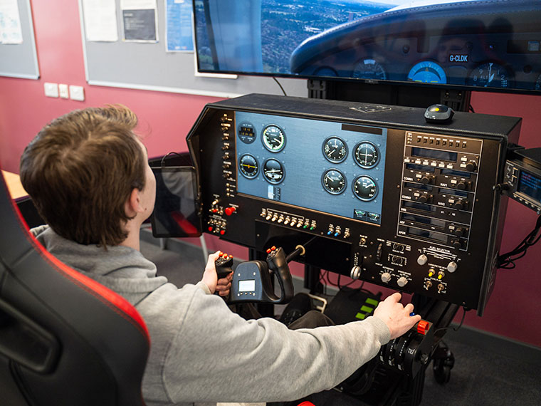 Someone using Rotherham College's aviation simulator