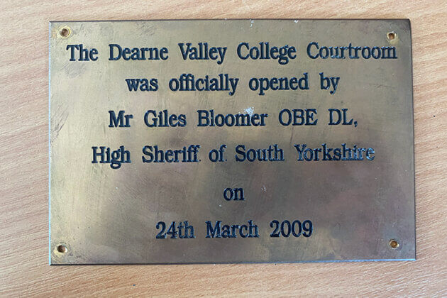 A plaque that reads; The Dearne Valley College Courtroom was officially was officially opened by Mr Giles Bloomer OBE DL, High Sheriff of Yorkshire on 24th March 2009.