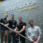 Your Space to feel good written on a wall with four people stood below it on a staircase