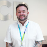 Conal White, Accounting Tutor - male with short dark hair wearing a white short sleeved shirt