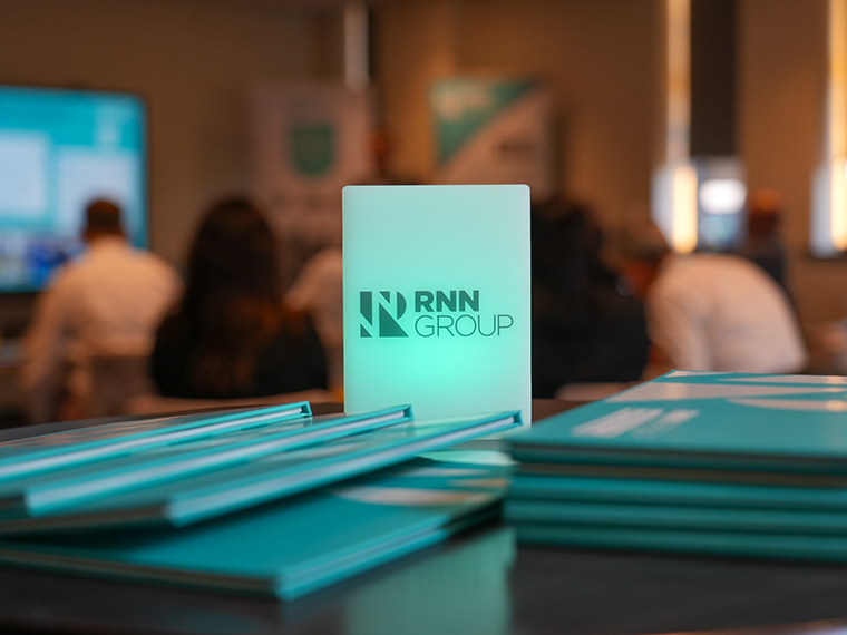 A pile of RNN Group prospectuses on a table