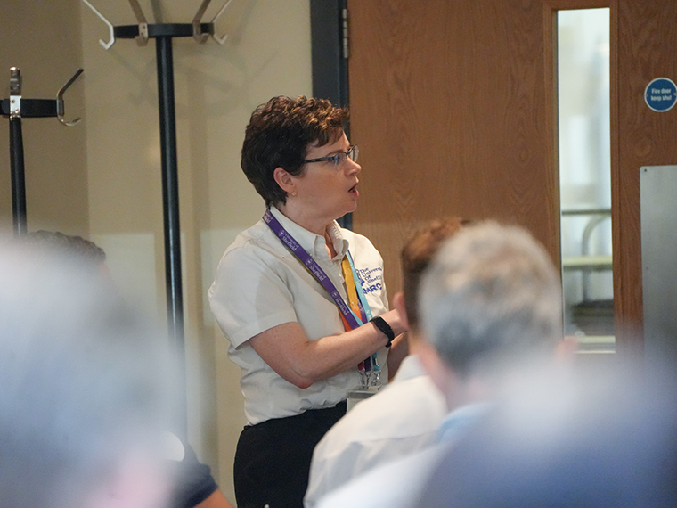 A female speaker stood at the front of an audience